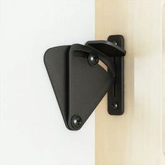 two black brackets mounted to the side of a wall