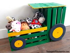 a wooden crate with stuffed animals in it