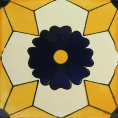 a blue and yellow flower is in the middle of a square tile design on a wall