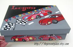 a box with cars painted on it is being held up by someone's hand