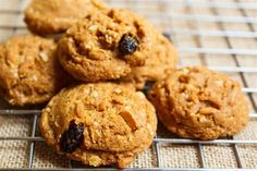 some cookies are on a cooling rack and have raisins in them as well