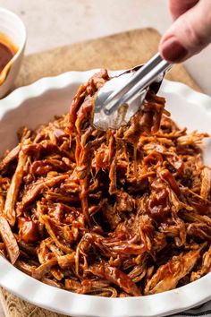 shredded pulled pork with bbq sauce in a white bowl