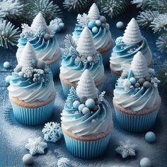 cupcakes decorated with blue frosting and white icing, surrounded by snowflakes