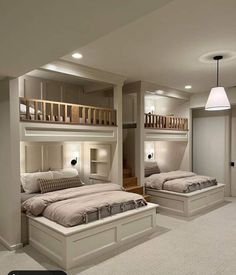 a bedroom with bunk beds and stairs in the ceiling is lit by two lamps on either side of the bed