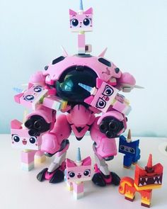 a pink robot with lots of toys around it