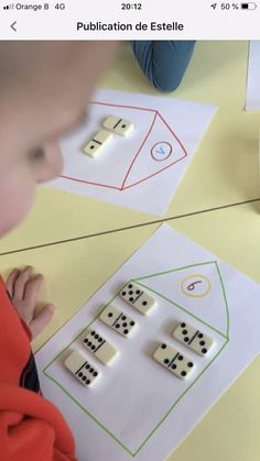 a young boy is playing with dices on the table