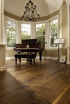 an empty room with a grand piano in it