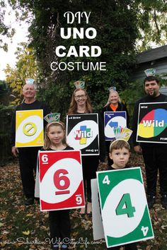 children holding up signs with numbers on them and the words diy uno card costume