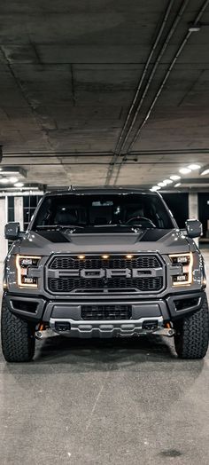 a truck parked in a parking garage with lights on it's front bumpers