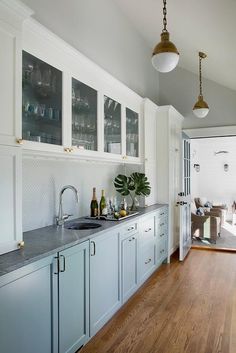 the kitchen is clean and ready to be used for cooking or entertaining, with white cabinetry and wood flooring