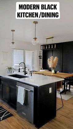 a kitchen with black cabinets and an island in the middle is seen from across the room