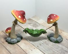 two mushrooms sitting on top of a wooden table