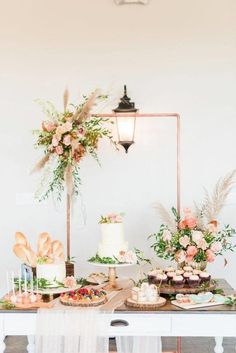 a table topped with lots of cakes and desserts