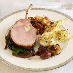 a white plate topped with meat and veggies