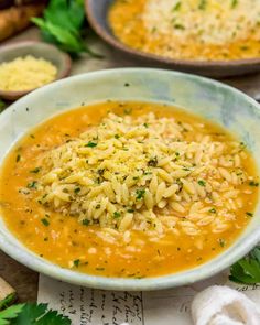 two bowls filled with soup and garnished with parmesan sprinkles