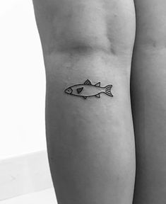 two people with tattoos on their legs and one has a fish tattoo on the leg