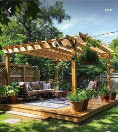 a wooden deck with potted plants on it and an attached pergoline over the top