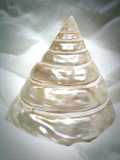 a glass cone sitting on top of a white sheet