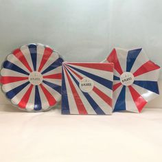 two plates with red, white and blue stripes on them sitting next to each other