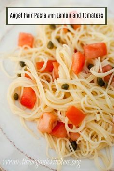 an angel hair pasta with lemon and tomatoes is on a plate, ready to be eaten