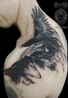 the back of a man's shoulder with an eagle tattoo on it