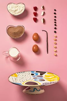 an assortment of baking ingredients on a pink background