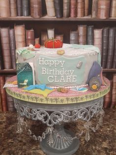 a birthday cake sitting on top of a table in front of a book shelf filled with books