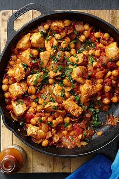 a skillet filled with chickpeas and tomatoes