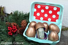 an egg carton filled with money and christmas decorations