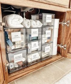 the drawers are filled with towels and other items in clear bins on top of them