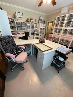 a home office with lots of drawers and desks in it's center area