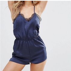 Navy Blue Crinkle Satin Romper With Really Beautiful Black Eyelash Lace Trim & T-Back Styling With Tiny Mother Of Pearl Buttons Down Center Back. Would Look Great Casually Styled With An Oversized Duster Sweater & Some Neutral Knee Boots, Or With A Leather Jacket, Tights And Booties For A Dressier Look. Has A Really Pretty Vintage Feel To It While Still Being Playful & Modern! Nwot Chic Stretch Summer Sleepwear, Chic V-neck Sleepwear For Night Out, Chic V-neck Sleepwear, Chic Sleeveless Sleepwear, Chic V-neck Sleepwear For Date Night, Chic Sleepwear For Date Night In Spring, Chic Sleepwear For Spring Parties, Chic Sleepwear For Party In Spring, Chic Spring Party Sleepwear