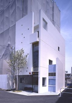 a tall white building sitting on the side of a road