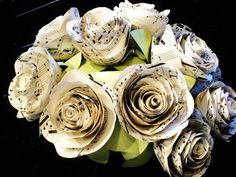 an arrangement of paper flowers made from sheet music