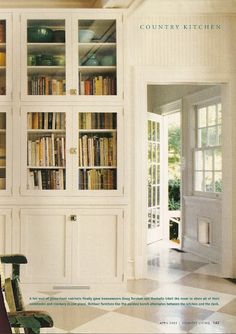 a chair sitting in front of a bookshelf filled with lots of book shelves