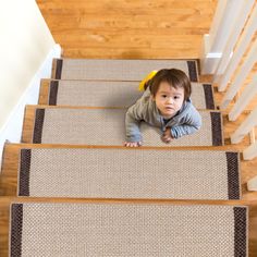 a small child is crawling down the stairs