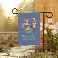 a blue welcome home baby card with two deers on it and flowers in the background