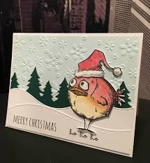 a christmas card with a bird wearing a santa's hat on top of it