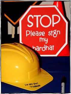 a yellow hard hat sitting next to a stop sign