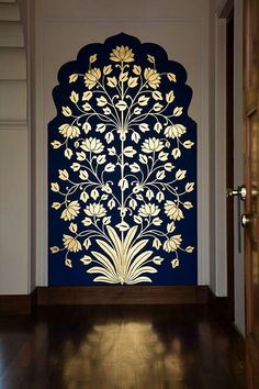 an intricately designed screen is displayed in front of a doorway with wooden floors and walls