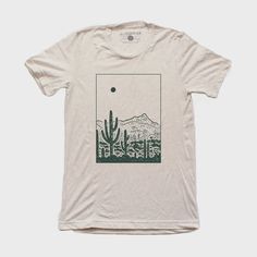 DescriptionThe Desert Tee is a screen-printed t-shirt with black water-based ink. Screen printed with care in Denver, Colorado using eco-friendly manufacturing processes to minimize their ecological footprint. Material52% Cotton, 48% Polyester. FitTrue to size, men's / unisex crew fit About Moore CollectionMoore Collection is founded by high school sweethearts Taylor and Tanner Barkin. They are self-taught in the art of screen printing, and what began as a fun hobby for in high school quickly ev Screen Print Designs Shirts, Unisex Tshirt Design Graphic Tees, Outdoorsy Graphic Tees, Nature T Shirt Design, Screen Printed T Shirt, Hand Printed Relaxed Fit Organic Cotton T-shirt, Eco-friendly Graphic Tee With Short Sleeves, Hand Printed Organic Cotton T-shirt, Relaxed Fit, Hand Printed Organic Cotton T-shirt In Relaxed Fit