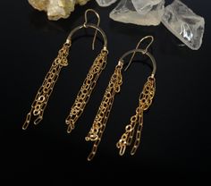 Enchanting 14-karat gold-filled, arch-shaped earrings with several dangling golden chains on either side of the arch will make for a wonderful, rainbow of fun for your ears. Not only are these pieces lightweight and simple to wear, but each set is unique and crafted with a diversity of gold-filled chains hanging from the arch. The picture is simply to give an example, and the pair in the image hangs to 3 1/4 inches. Should you wish for a different length, such as shoulder grazers, kindly send me 14k Gold Filled Chain Dangle Earrings, Yellow Gold Chain Brass Earrings, Gold Chain Dangle Brass Earrings, Gold Drop Chandelier Earrings With Adjustable Chain, Gold Chandelier Drop Earrings With Adjustable Chain, Gold Chain Dangle Earrings In Brass, Gold Chain Long Drop Earrings As Gift, Gold Chain Long Drop Earrings For Gift, 14k Gold Box Chain Dangle Earrings