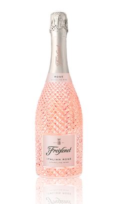 a bottle of pink wine sitting on top of a table