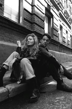 black and white photograph of two people sitting on a bench