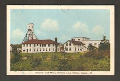 an old postcard with a large white building in the foreground and a water tower on top