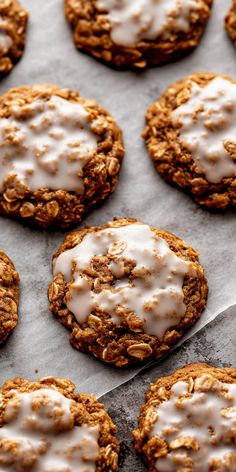 cookies with white icing are on a baking sheet