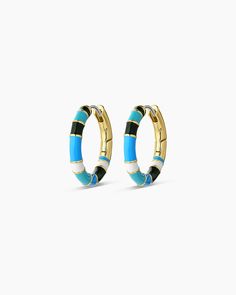 The Gigi Enamel Stripe Hoop earrings instantly elevate an outfit. Their lightweight, statement-making style features an enamel design accented by a stunning gold-plated finish. Easily style them with other gold or diamond studs and huggies to complete your look! Profile diameter measures 3/4" Hand painted enamel Surgical steel post with hinge closure Available in 18k gold plated brass Avoid contact with anything containing derivatives of alcohol Trendy Enamel Hoop Jewelry, Trendy Gold Enamel Hoop Earrings, Trendy Round Enamel Hoop Earrings, Modern Enamel Hoop Earrings, Hoop Huggie Earrings In Enamel, Steel Post, Diamond Studs, 18k Gold, Gold Plate