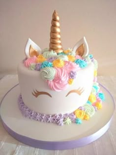 there is a cake decorated with flowers and a unicorn's horn