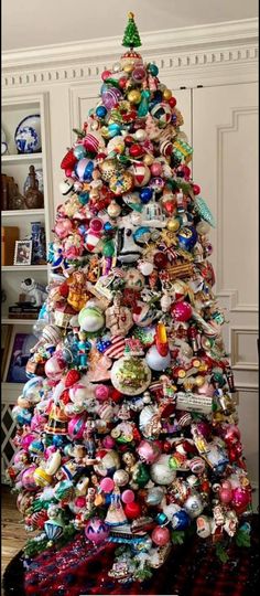 a christmas tree made out of ornaments in the shape of an ornament is shown