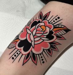 a woman's arm with a flower tattoo on it